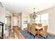 Bright dining room with stylish chandelier and hardwood floors with entry view at 13082 Overview Dr # 5A, Fishers, IN 46037