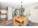 Cozy dining room with chandelier, wooden table, and views of the entry and kitchen at 13082 Overview Dr # 5A, Fishers, IN 46037