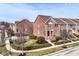 Aerial view of brick townhomes with well-maintained landscaping and street at 13082 Overview Dr # 5A, Fishers, IN 46037