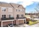 A two-story townhouse with multiple balconies, a driveway, and a well-maintained front yard at 13082 Overview Dr # 5A, Fishers, IN 46037