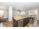 Bright open kitchen with a large granite island, modern appliances, and an adjacent breakfast nook at 13082 Overview Dr # 5A, Fishers, IN 46037