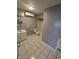 Tiled bathroom featuring a tub, toilet, and sink with cabinet, and a heater at 1410 St Paul St, Indianapolis, IN 46203