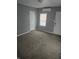 Neutral bedroom with carpeting, mini-split AC unit, and natural light from window at 1410 St Paul St, Indianapolis, IN 46203