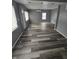 Open-concept living room featuring new flooring, freshly painted walls, and natural light at 1410 St Paul St, Indianapolis, IN 46203