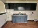 Functional laundry area with painted cabinets, sink and laminate flooring at 151 N 8Th Ave, Beech Grove, IN 46107