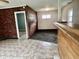 Interior view featuring brick and wood paneling, with an open doorway to a carpeted area at 151 N 8Th Ave, Beech Grove, IN 46107