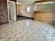 Inviting living room featuring a brick wall, a serving bar, and light-colored tile flooring at 151 N 8Th Ave, Beech Grove, IN 46107