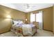 This bedroom has a window and ceiling fan, with a neutral colored carpet at 153 Monticello Ct, Noblesville, IN 46060