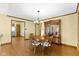 Elegant dining room with hardwood floors, modern lighting, and classic china cabinet at 153 Monticello Ct, Noblesville, IN 46060