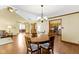 Dining room with hardwood floors, chandelier, open to the kitchen and living areas at 153 Monticello Ct, Noblesville, IN 46060