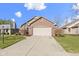 Charming brick home featuring an attached two-car garage and manicured landscaping under a sunny sky at 153 Monticello Ct, Noblesville, IN 46060