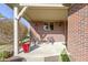 Inviting front porch with brick exterior, decorative seating, and a charming, covered entrance at 153 Monticello Ct, Noblesville, IN 46060