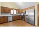 Well-lit kitchen features stainless steel appliances, wood cabinets, and a modern backsplash at 153 Monticello Ct, Noblesville, IN 46060