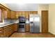 Bright kitchen showcasing stainless steel appliances, wood cabinets, and granite countertops at 153 Monticello Ct, Noblesville, IN 46060