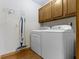 This laundry room features white walls, wood-look floors, a washer, and a dryer at 153 Monticello Ct, Noblesville, IN 46060