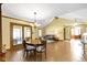 Open-concept living room featuring a wood dining table and a comfortable seating area with access to a patio at 153 Monticello Ct, Noblesville, IN 46060