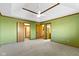 This main bedroom features green walls, a tray ceiling with a ceiling fan, and a walk-in closet at 153 Monticello Ct, Noblesville, IN 46060
