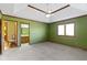 This main bedroom has a beige carpet and a view into the en-suite bathroom and a large window at 153 Monticello Ct, Noblesville, IN 46060