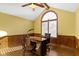 Well-lit home office features a wood desk, wainscoting, and a vaulted ceiling at 153 Monticello Ct, Noblesville, IN 46060