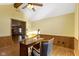 Spacious office space featuring a desk, wainscoting, and a ceiling fan at 153 Monticello Ct, Noblesville, IN 46060