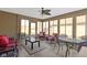 Bright sunroom featuring many windows, a ceiling fan, neutral flooring, and comfortable seating at 153 Monticello Ct, Noblesville, IN 46060