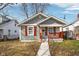 Charming single-story home features gray siding, red shutters, and a cozy front porch at 1540 N Chester Ave, Indianapolis, IN 46201