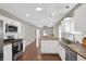 Modern kitchen featuring stainless steel appliances, white cabinets, and butcher block counters at 1540 N Chester Ave, Indianapolis, IN 46201