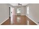 Bright living area with hardwood floors and neutral walls, leading to a pink front door at 1540 N Chester Ave, Indianapolis, IN 46201
