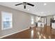 Bright living area with gleaming hardwood floors, a ceiling fan, and ample natural light at 1540 N Chester Ave, Indianapolis, IN 46201