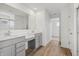 Elegant bathroom featuring double vanity sinks with gray cabinets, white countertops, and wood floors at 15982 Meadow Frost Ct, Fishers, IN 46037