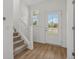Welcoming entryway featuring a carpeted staircase and view of the outdoors at 15982 Meadow Frost Ct, Fishers, IN 46037