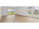 Bright and airy living room featuring wood floors, sliding glass doors, and multiple windows at 15982 Meadow Frost Ct, Fishers, IN 46037