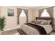 Staged bedroom with upholstered headboard and hardwood floors at 1701 Nelson Ave, Indianapolis, IN 46203