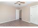 Cozy bedroom with laminate flooring, neutral colored walls, closet, and entrance to another room at 1701 Nelson Ave, Indianapolis, IN 46203