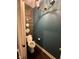 Small half bathroom showcasing a white toilet, wood-look accent wall, and a modern chandelier at 1740 Golden Field Dr, Greenwood, IN 46143