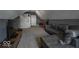 Cozy bonus room with plush carpet, modern furniture, and ample space for relaxation and entertainment at 1740 Golden Field Dr, Greenwood, IN 46143