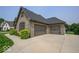 A home featuring a spacious three-car garage and an extra wide concrete driveway in front of the home at 1740 Golden Field Dr, Greenwood, IN 46143
