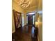 Inviting foyer with a statement light fixture, hardwood floors and a custom barn door on the left at 1740 Golden Field Dr, Greenwood, IN 46143