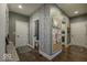 Inviting hallway with hardwood floors, birch tree wallpaper, and neutral paint colors at 1740 Golden Field Dr, Greenwood, IN 46143