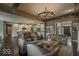 Open-concept living room with a stone fireplace, wooden beam accents, hardwood floors, and neutral-toned furniture at 1740 Golden Field Dr, Greenwood, IN 46143