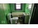 Modest bathroom featuring a standard toilet, single sink vanity, and a classic clawfoot bathtub at 18 N Sherman Dr, Indianapolis, IN 46201