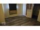 Bedroom featuring newly installed laminate flooring and a doorway at 18 N Sherman Dr, Indianapolis, IN 46201