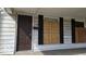 Home exterior featuring front door and boarded windows at 18 N Sherman Dr, Indianapolis, IN 46201
