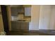 Features a kitchen with gray cabinets, a stainless-steel sink, and dark, vinyl flooring at 18 N Sherman Dr, Indianapolis, IN 46201