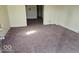 Vacant living room featuring neutral carpeting and natural light at 18 N Sherman Dr, Indianapolis, IN 46201
