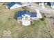 Aerial view of a home with a large yard, screened-in porch, and concrete patio at 19041 Karyn Ln, Westfield, IN 46062