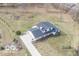 Aerial view of home surrounded by a large yard with a long driveway and concrete patio at 19041 Karyn Ln, Westfield, IN 46062