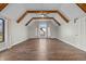 Spacious bedroom featuring vaulted ceilings, wood beams, hardwood floors, and a large window allowing for plenty of natural light at 19041 Karyn Ln, Westfield, IN 46062