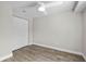 Bedroom features a ceiling fan, neutral paint, hardwood floors, and a closet with white double doors at 19041 Karyn Ln, Westfield, IN 46062