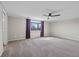 Expansive primary bedroom with ceiling fan and window with purple curtains at 19041 Karyn Ln, Westfield, IN 46062